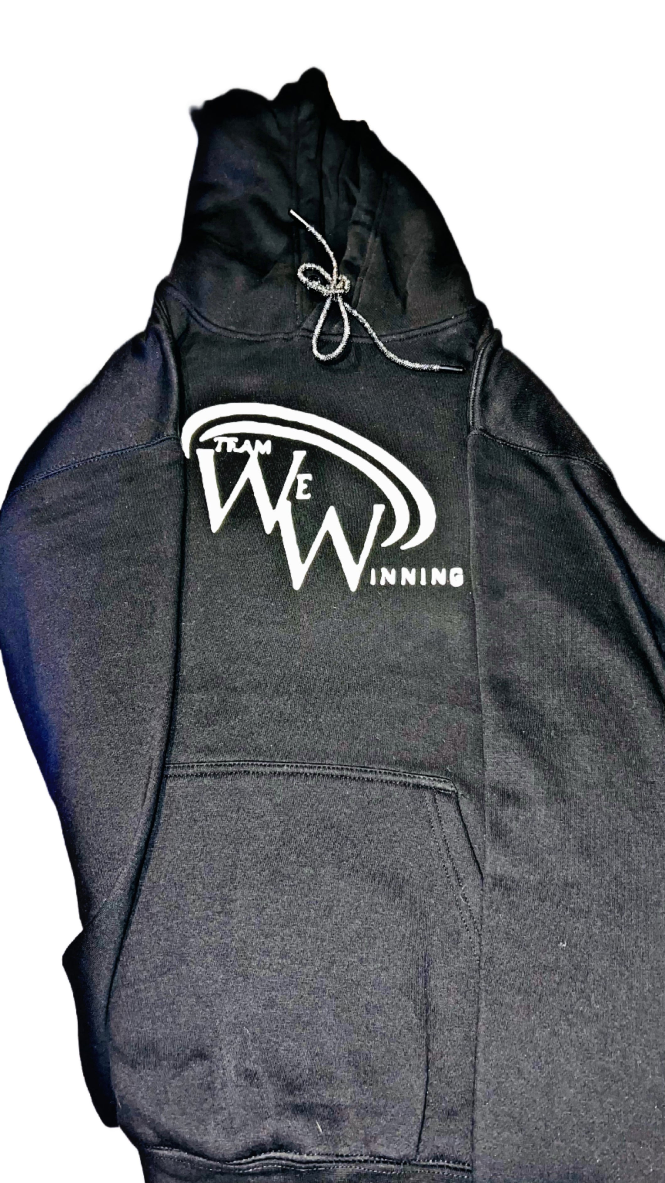 Black Team We Winning hoodie with white logo on a white background