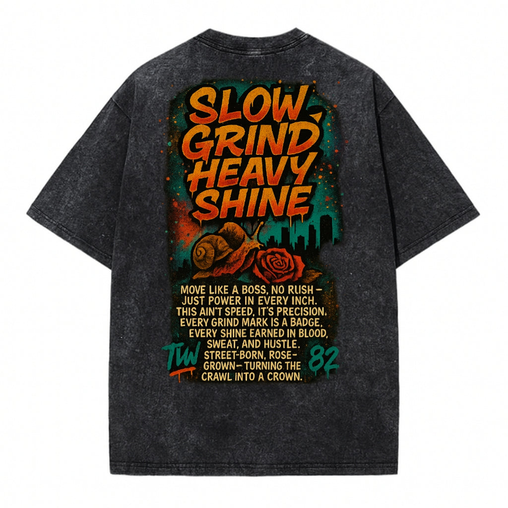 Black T-shirt back with colorful 'Slow Grind Heavy Shine' graphic and text design on a white background