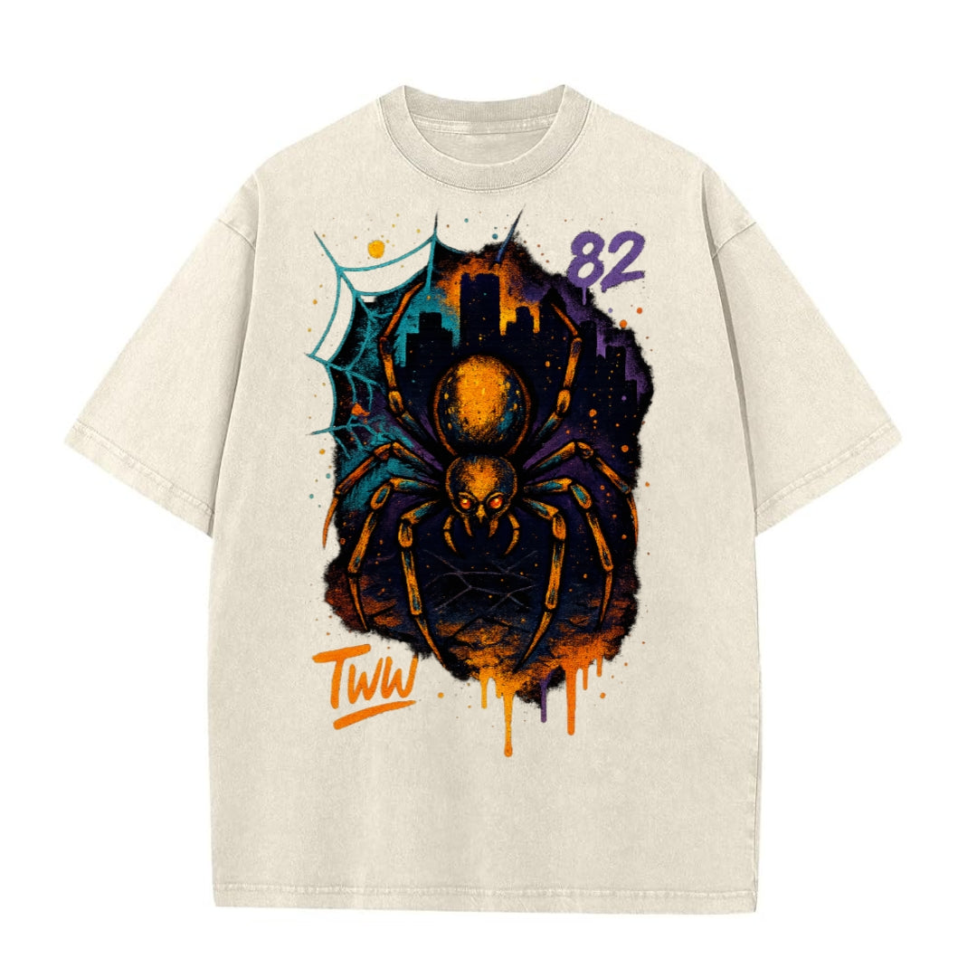 Beige T-shirt featuring spider graphic with city skyline and '82' text on a white background