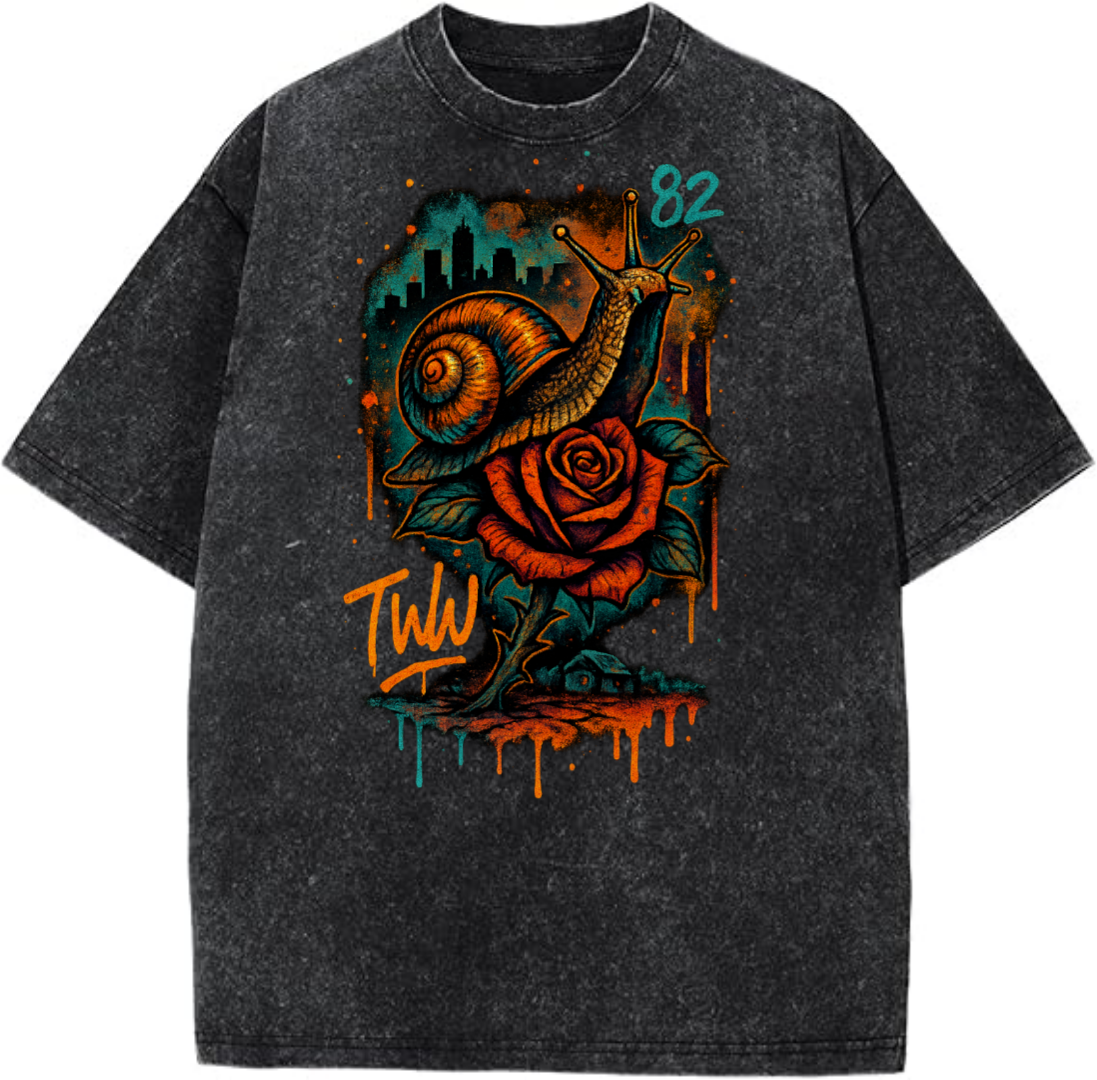 Black T-shirt with colorful snail and rose graphic, cityscape design, and '82' text on a white background